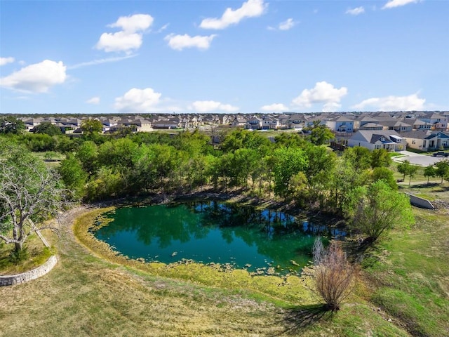 aerial view of property and surrounding area featuring nearby suburban area and a nearby body of water