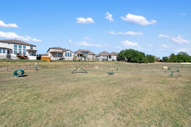 view of yard with a dog friendly area and a residential view
