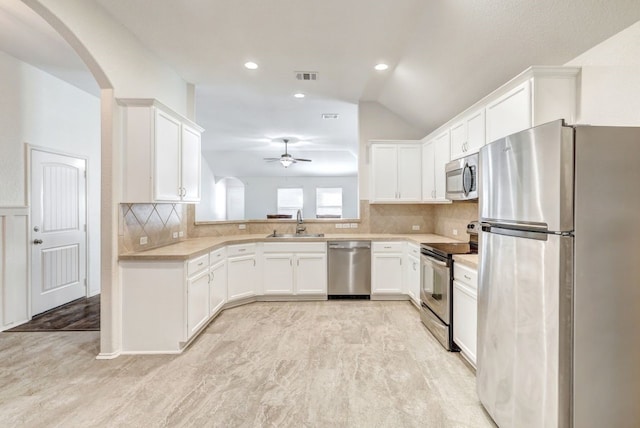 kitchen with backsplash, white cabinetry, sink, and appliances with stainless steel finishes