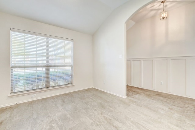 unfurnished room with vaulted ceiling