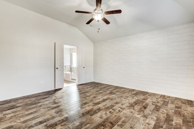 empty room with ceiling fan, wood-type flooring, and vaulted ceiling