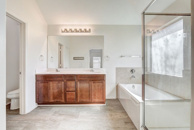 full bathroom featuring vanity, toilet, and independent shower and bath