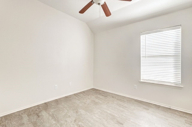 empty room with ceiling fan and lofted ceiling