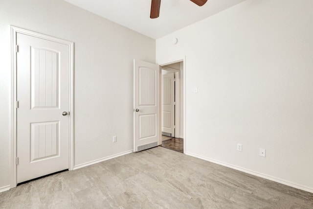 unfurnished bedroom featuring ceiling fan and light carpet