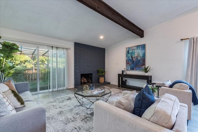 tiled living room with a textured ceiling, lofted ceiling with beams, and a fireplace