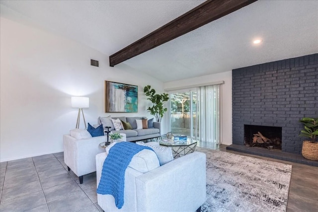 living room featuring a textured ceiling, a fireplace, vaulted ceiling, and tile patterned flooring