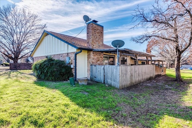 back of property featuring a yard