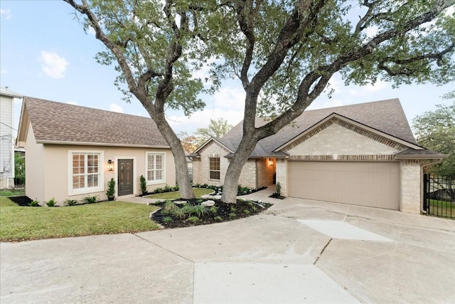 view of front facade with a front yard and a garage