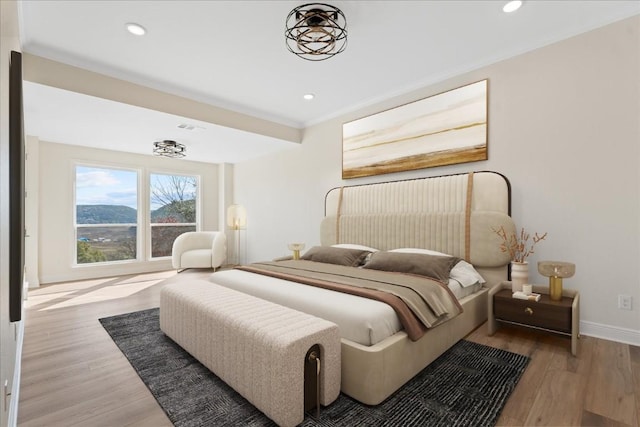 bedroom featuring ornamental molding, light wood finished floors, recessed lighting, and baseboards