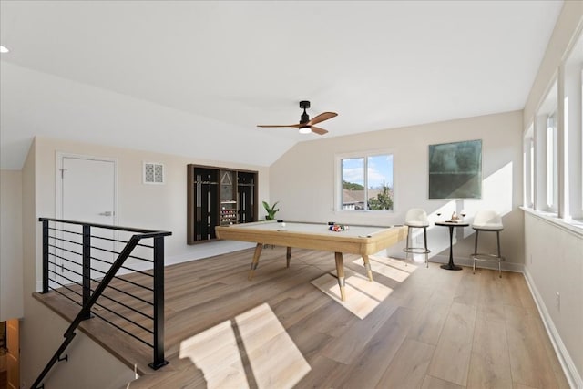 playroom with light wood-style flooring, visible vents, baseboards, and vaulted ceiling