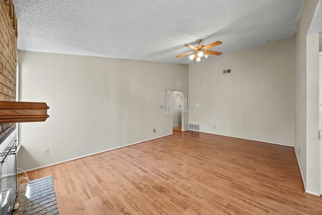 unfurnished living room featuring hardwood / wood-style floors, a textured ceiling, and ceiling fan