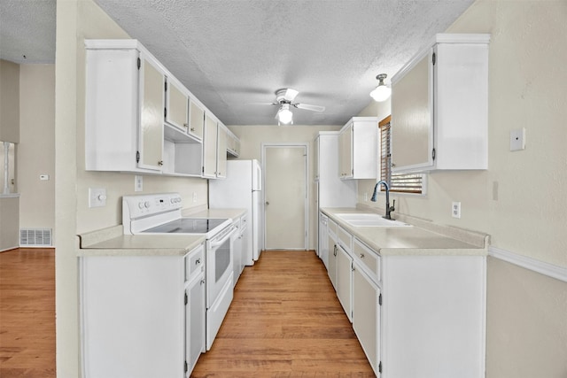 kitchen with white cabinetry, sink, light hardwood / wood-style flooring, white range with electric cooktop, and a textured ceiling