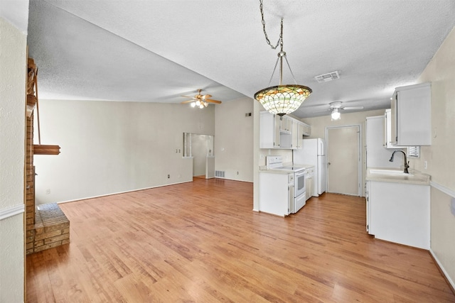 kitchen with white cabinets, white electric range oven, light hardwood / wood-style floors, and sink