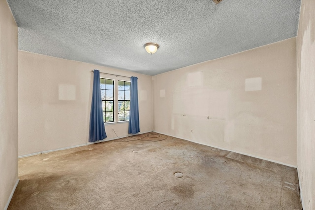 unfurnished room with carpet flooring and a textured ceiling