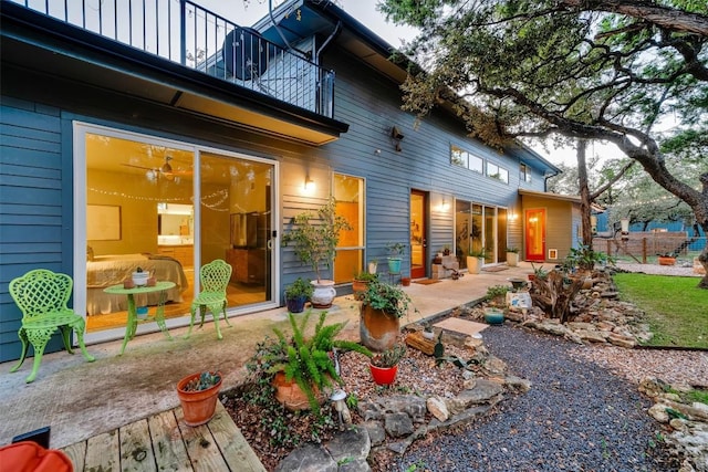 back of property with a patio area and a balcony