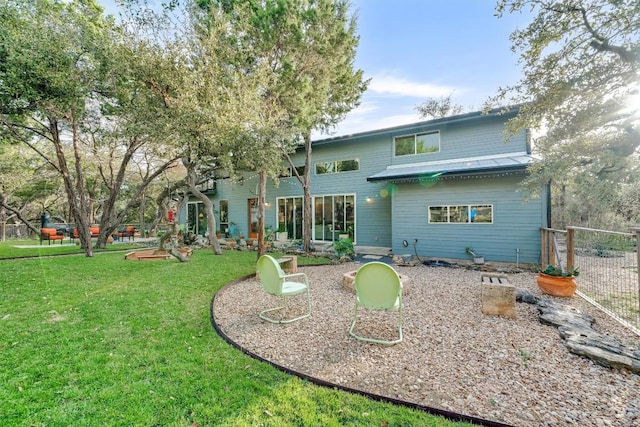 rear view of property with a lawn