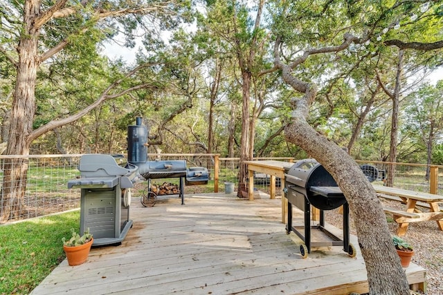 wooden terrace with a grill