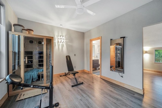 workout area with ceiling fan and wood-type flooring