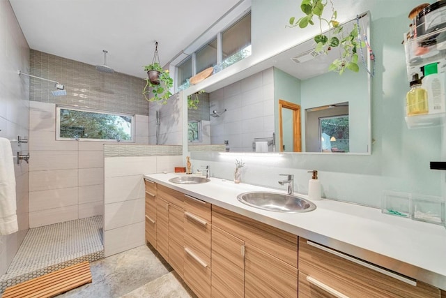 bathroom featuring toilet, vanity, and tiled shower