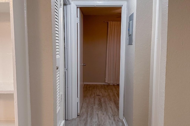 corridor with light hardwood / wood-style floors