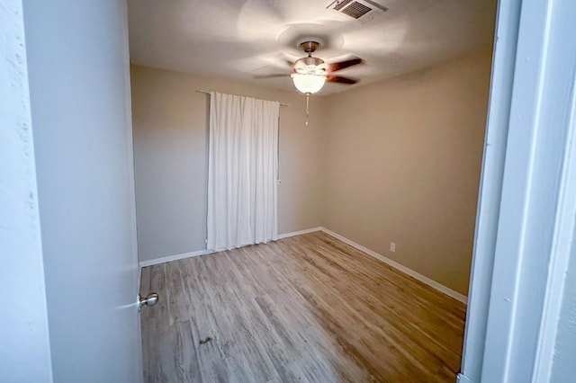 unfurnished room featuring ceiling fan and light wood-type flooring