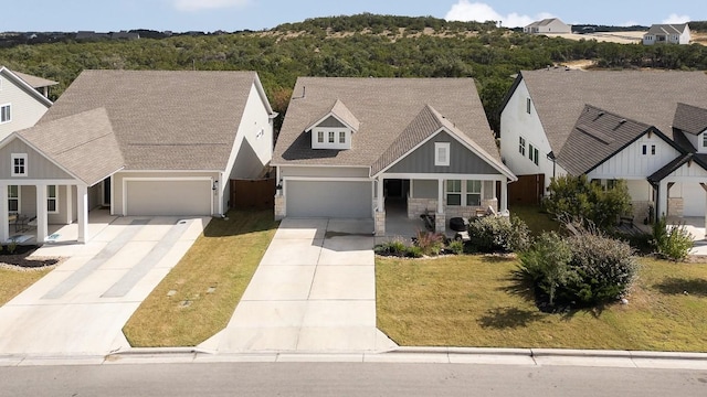 view of front facade featuring a front lawn, covered porch, and a garage