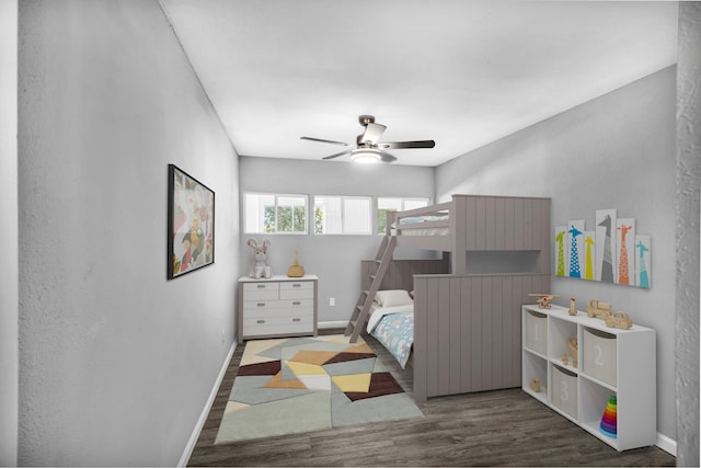 bedroom with ceiling fan and dark hardwood / wood-style flooring