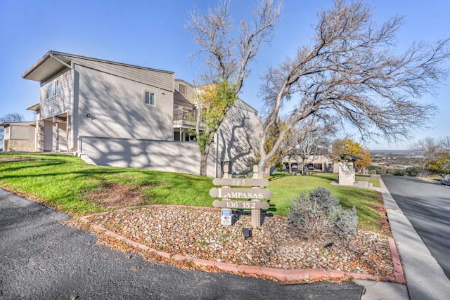 view of side of property with a lawn and a garage