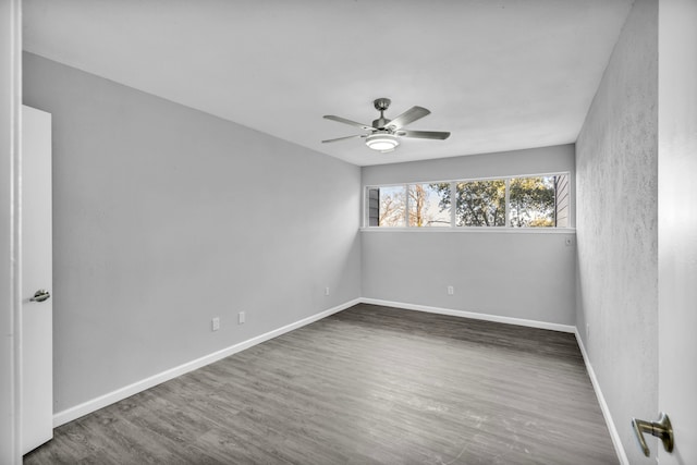 unfurnished room with dark hardwood / wood-style flooring and ceiling fan