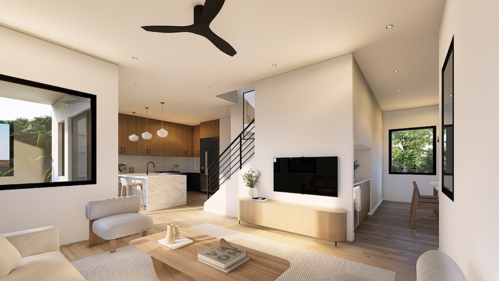 living room with ceiling fan, sink, and light hardwood / wood-style flooring