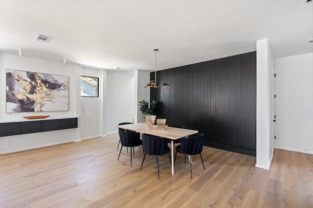 dining space with light hardwood / wood-style flooring