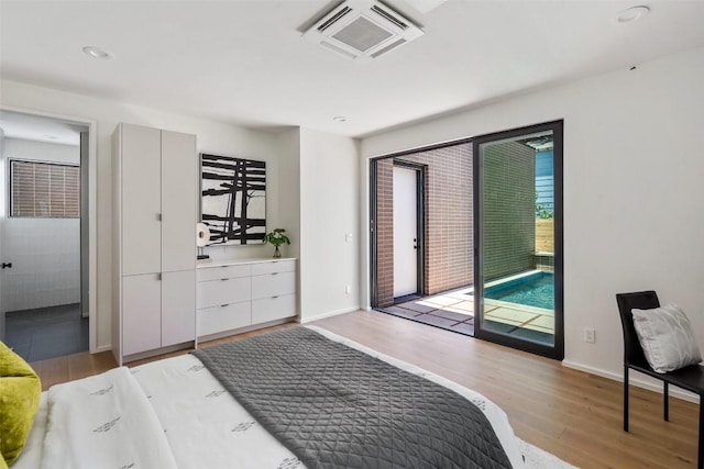 bedroom featuring light hardwood / wood-style floors and access to outside