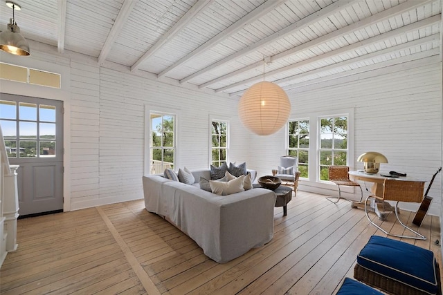 sunroom / solarium featuring beam ceiling and wood ceiling