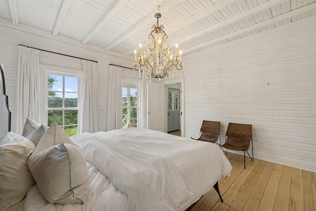 bedroom with a chandelier, beam ceiling, hardwood / wood-style flooring, and wood ceiling