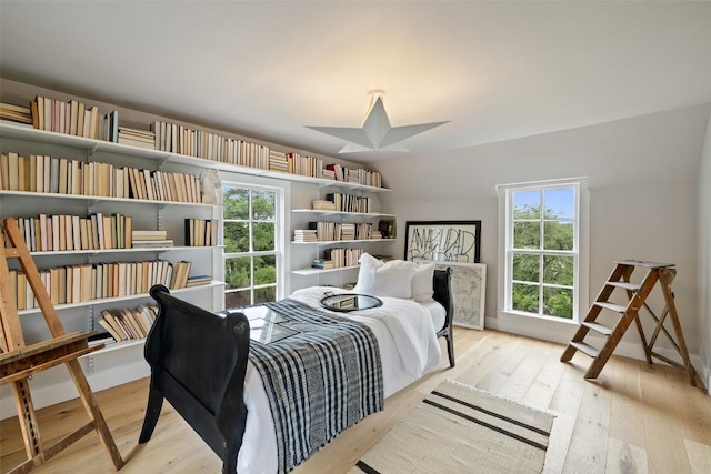 bedroom featuring light hardwood / wood-style flooring and multiple windows