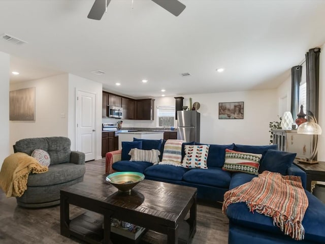 living room with dark hardwood / wood-style floors and ceiling fan