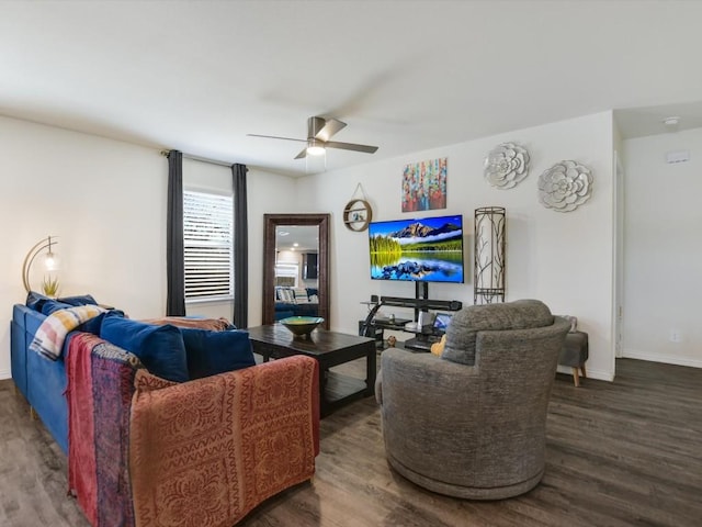 living room featuring ceiling fan and dark wood-type flooring