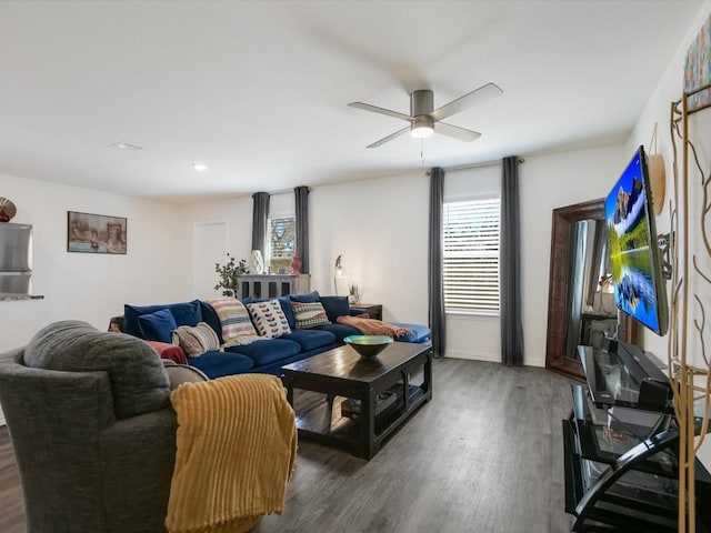 living room featuring dark hardwood / wood-style floors and ceiling fan