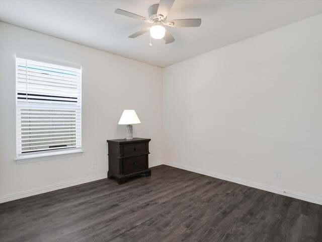 unfurnished room featuring ceiling fan and dark wood-type flooring