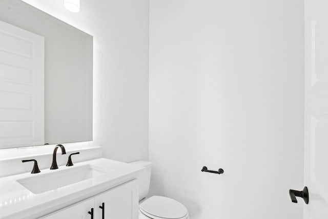 220 Reata Ridge Loop, Liberty Hill, TX 78642 - half bathroom featuring vanity and toilet