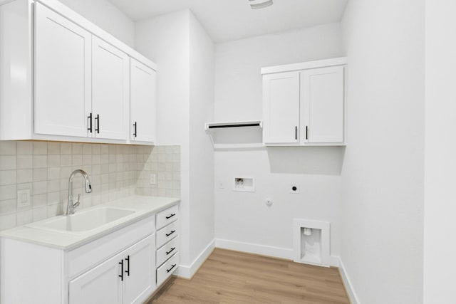 220 Reata Ridge Loop, Liberty Hill, TX 78642 - laundry area featuring electric dryer hookup, cabinet space, washer hookup, gas dryer hookup, and light wood-style floors