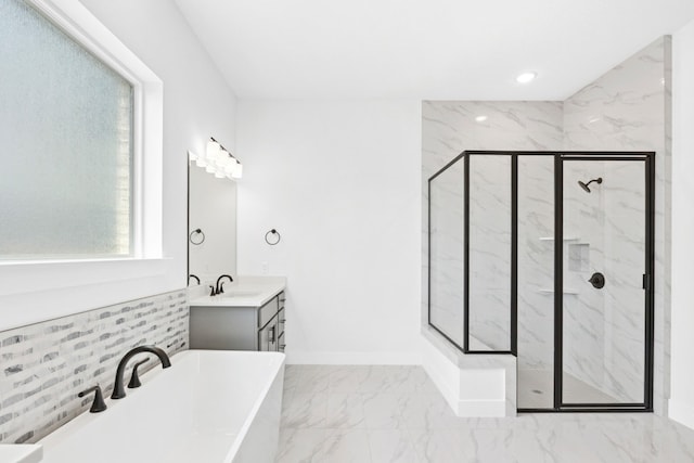 220 Reata Ridge Loop, Liberty Hill, TX 78642 - bathroom featuring marble look tiles, a marble finish shower, a freestanding bath, vanity, and baseboards