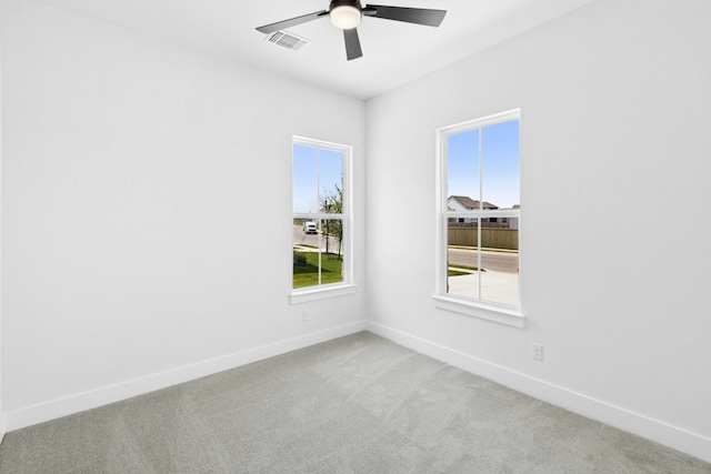 220 Reata Ridge Loop, Liberty Hill, TX 78642 - spare room featuring light colored carpet, ceiling fan, and baseboards