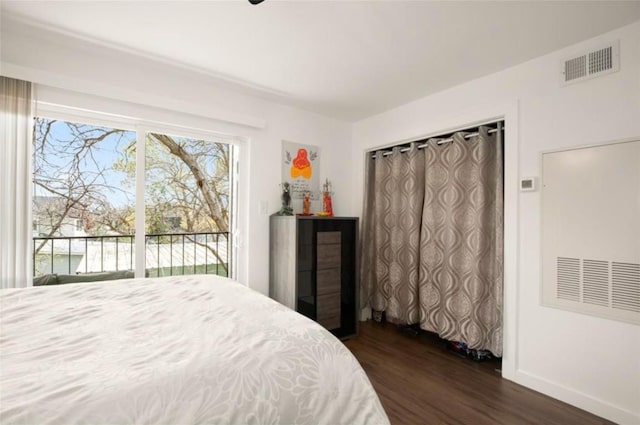 bedroom featuring access to exterior and dark hardwood / wood-style flooring