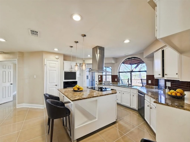 kitchen with a kitchen island, decorative light fixtures, white cabinetry, dark stone counters, and island exhaust hood