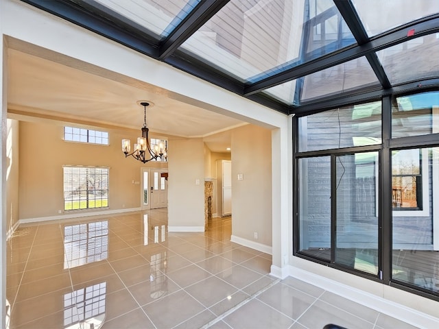 tiled empty room featuring beamed ceiling, crown molding, and a chandelier