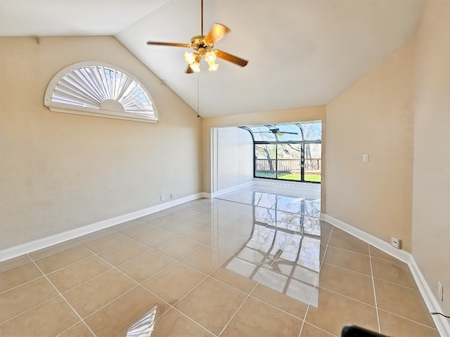 unfurnished room with light tile patterned flooring, vaulted ceiling, and ceiling fan