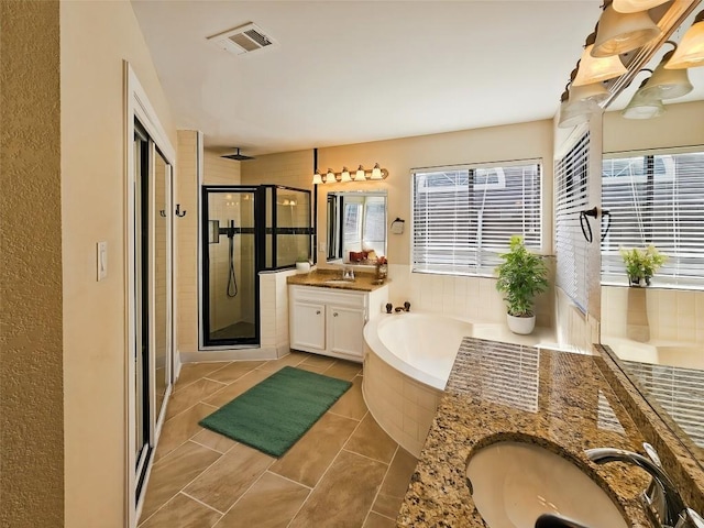 bathroom featuring independent shower and bath and vanity