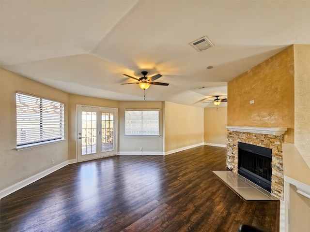 unfurnished living room featuring dark hardwood / wood-style flooring, a fireplace, and ceiling fan