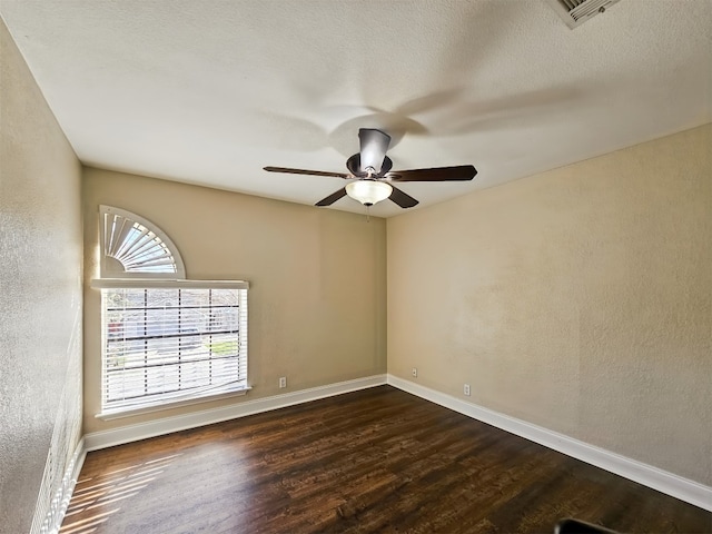 unfurnished room featuring ceiling fan, dark hardwood / wood-style floors, and a textured ceiling